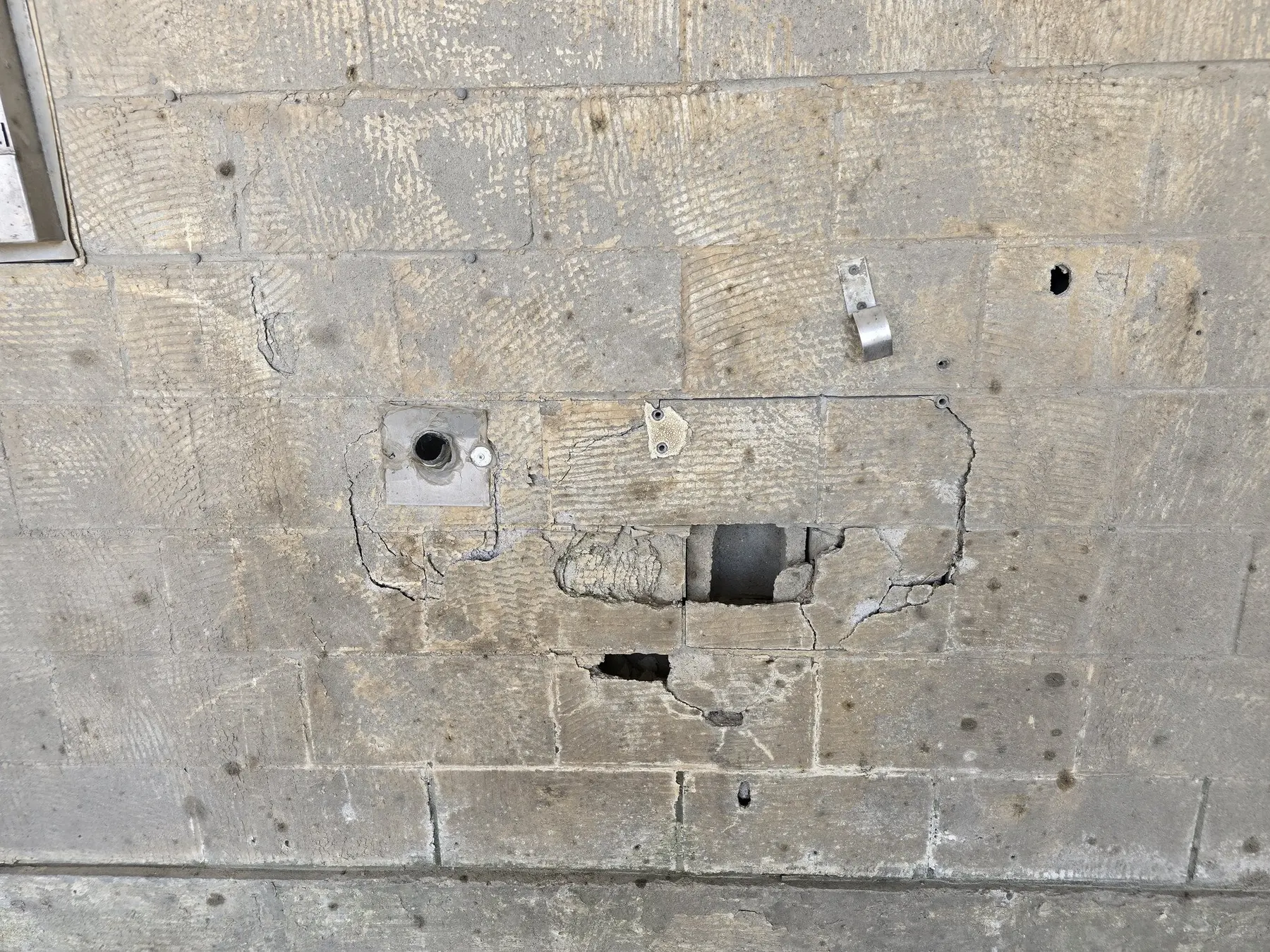 Damaged concrete masonry wall documented during a commercial structural assessment