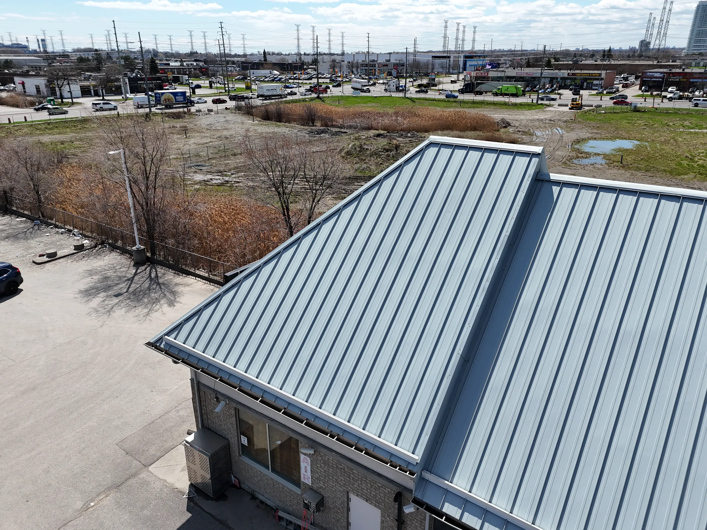 Commercial building roof and site with building systems visible