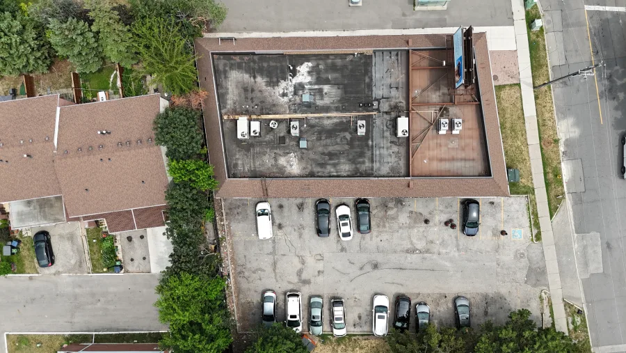 Aerial overview of a commercial roof, mechanical equipment and surrounding site
