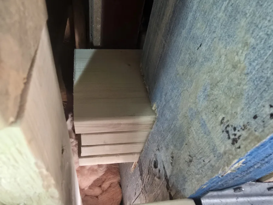 Close view of timber framing bearing and its connection to an existing wall