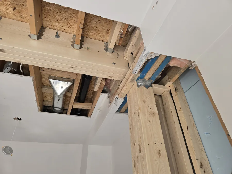 Engineered timber beam and framing reinforcement around a new interior opening