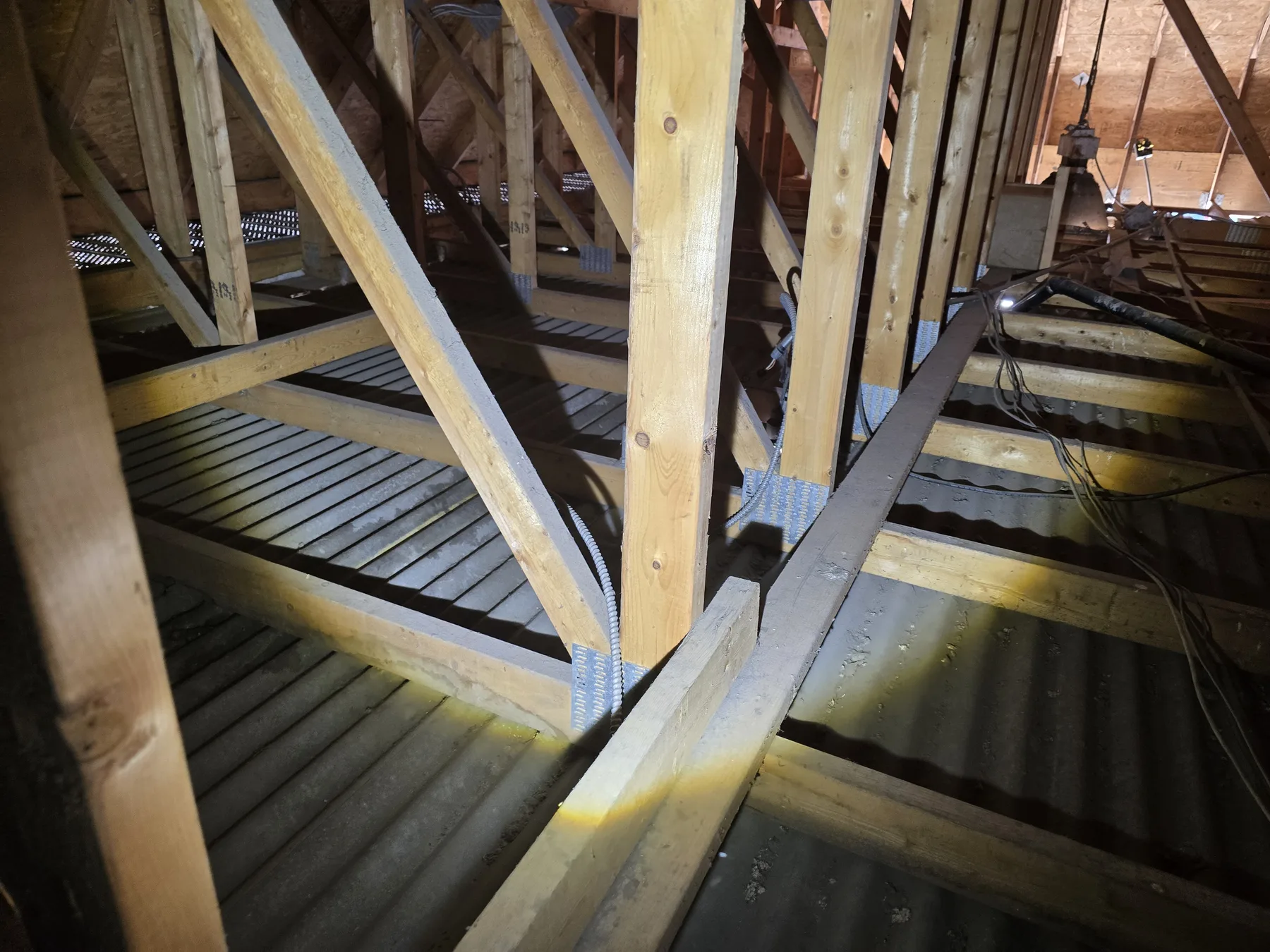 Roof trusses and framing connections reviewed during a structural assessment