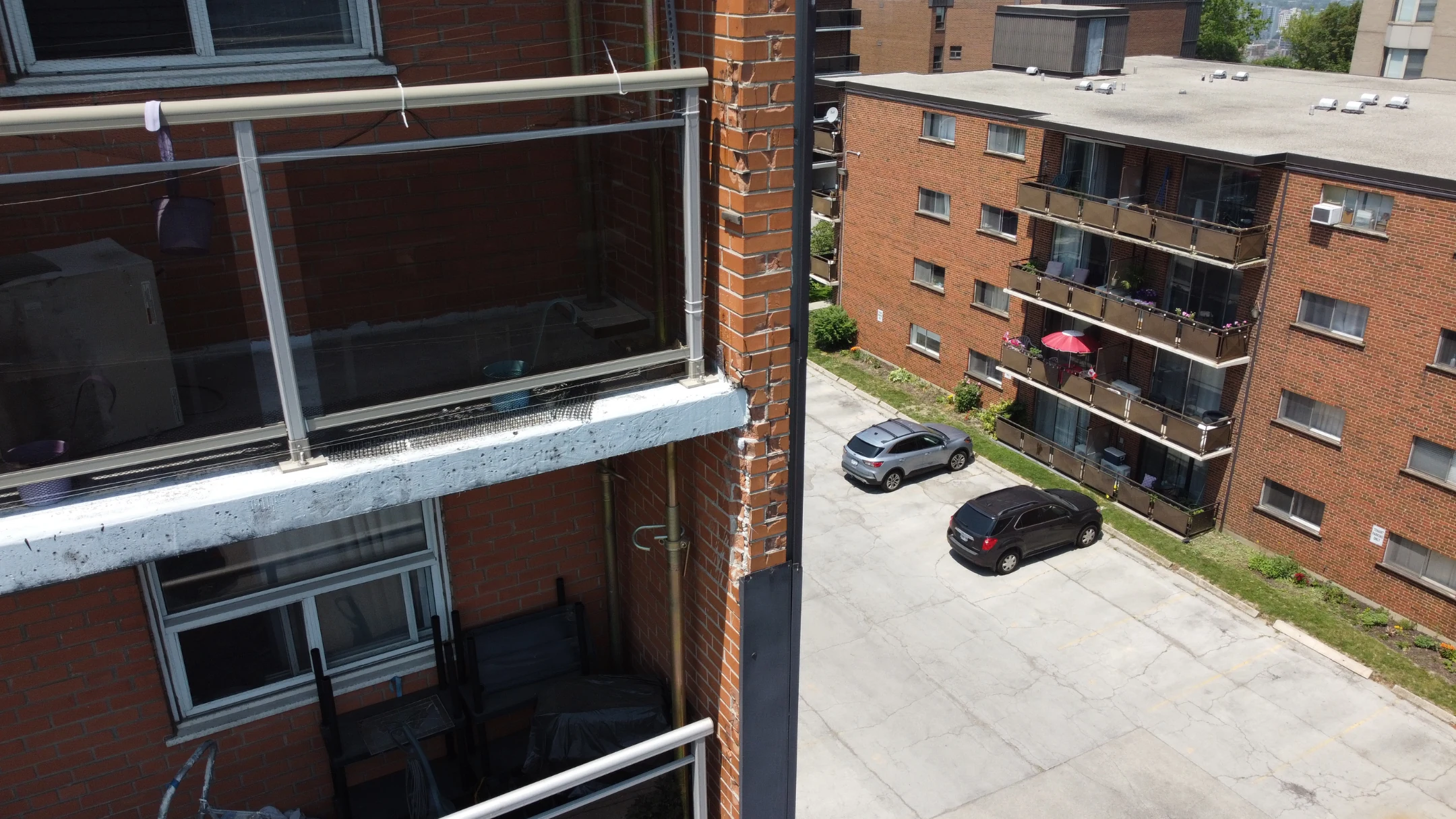 Exterior view of a mid-rise commercial building under structural assessment, showing facade and parapet detail